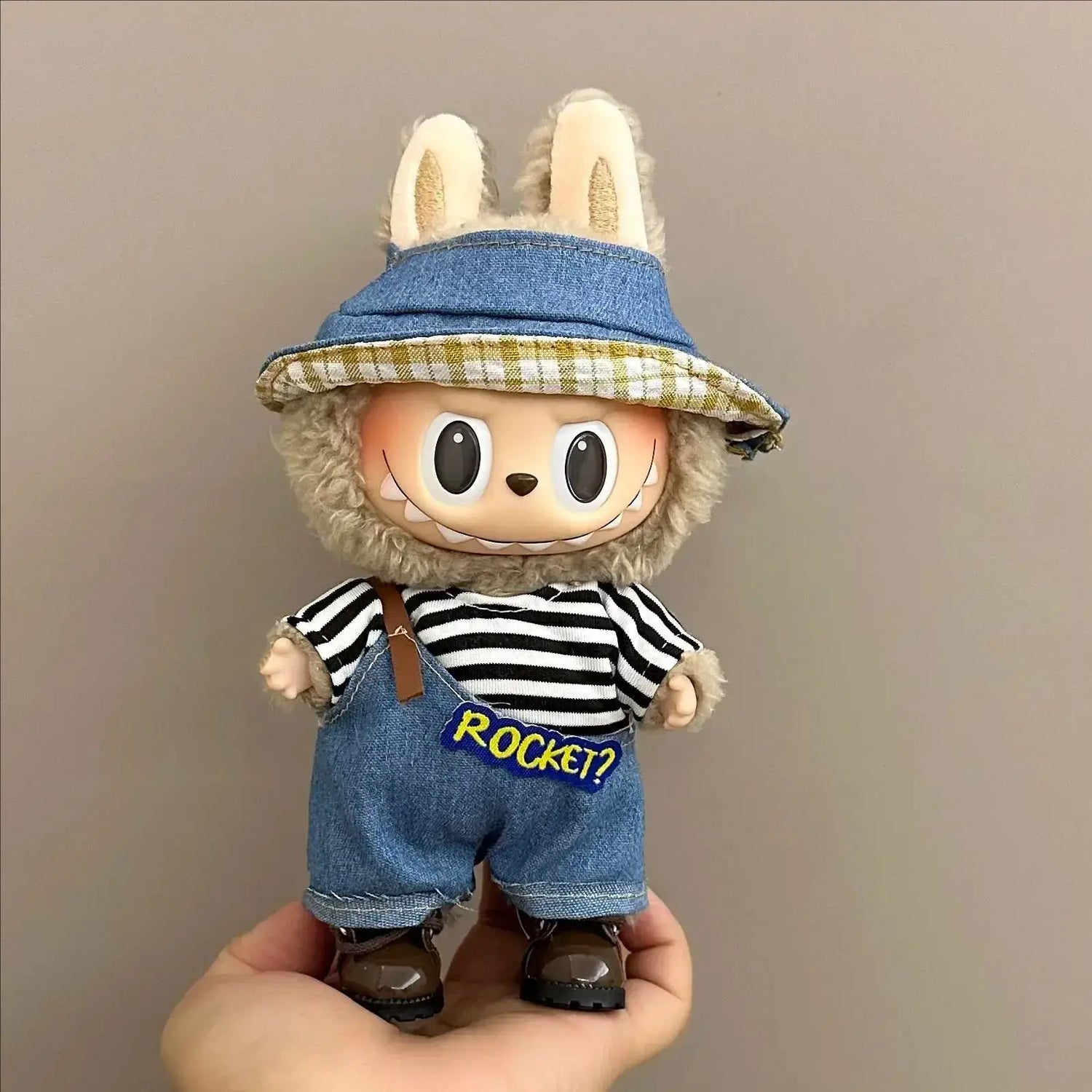 Labubu doll clothes 17cm on a cute doll wearing a striped shirt and denim overalls with a hat.
