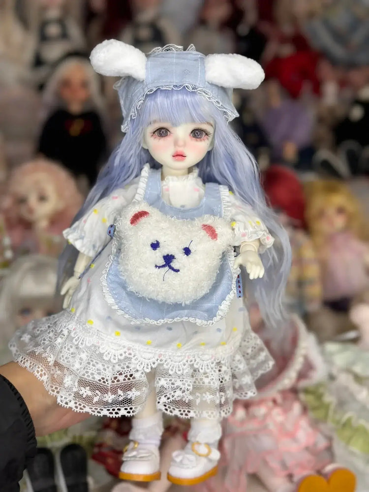 A cute 6 niveltä prinsessanukke meikillä doll dressed in a bunny outfit with a fluffy bag and pastel colors.