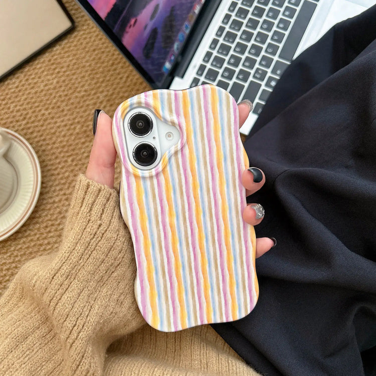 iPhone 2-in-1 striped phone case with colorful stripes, held in a hand with a cozy sweater background.