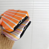 iPhone 2-in-1 striped phone case showcasing vibrant striped design and charging ports.