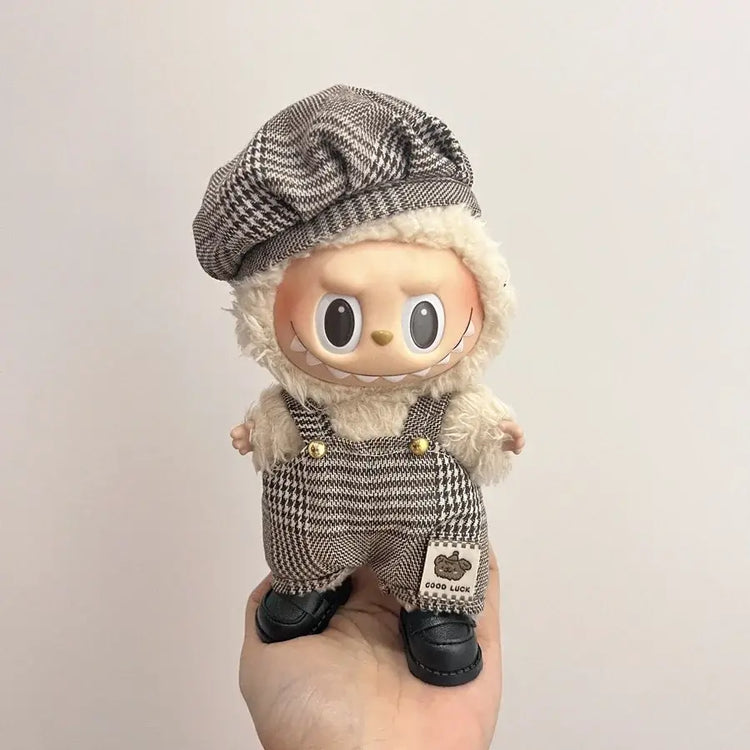Labubu doll clothes 17cm displayed on a cute doll wearing a stylish hat and checkered overalls.