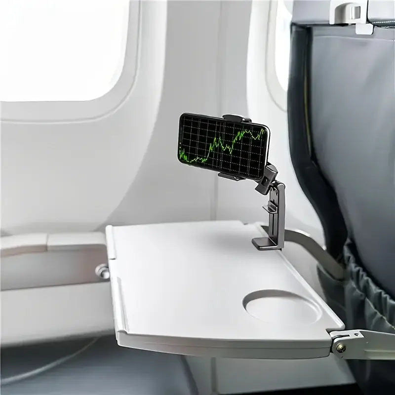 hands-free phone holder for car and desk attached to an airplane tray table with a phone displaying graphs