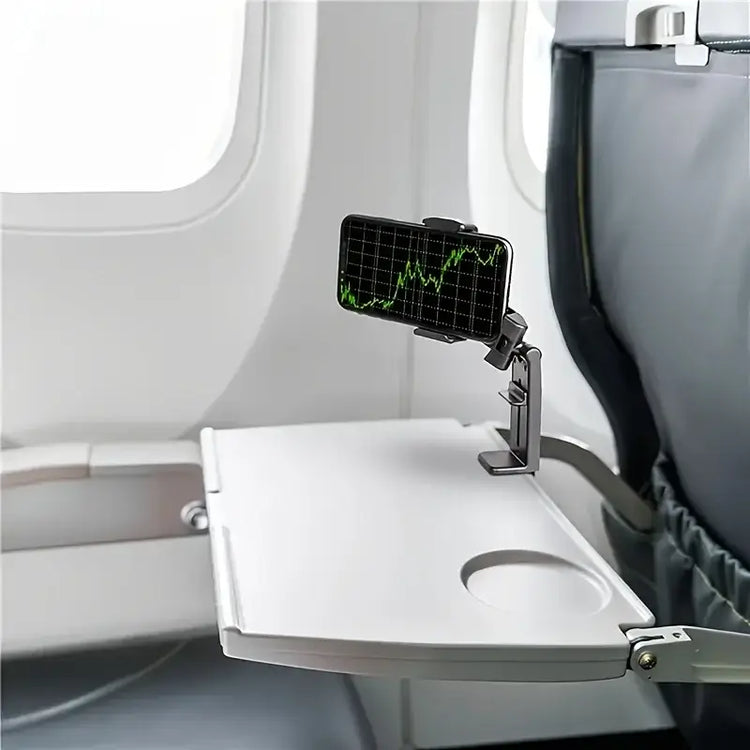 hands-free phone holder for car and desk attached to an airplane tray table with a phone displaying graphs