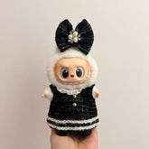 Labubu doll clothes 17cm dressed in a stylish black outfit with a large bow and pearl accents.