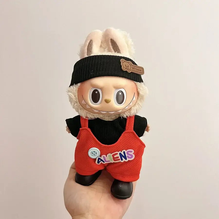 Cute Labubu doll dressed in red overalls and black beanie, showcasing trendy Labubu doll clothes 17cm.