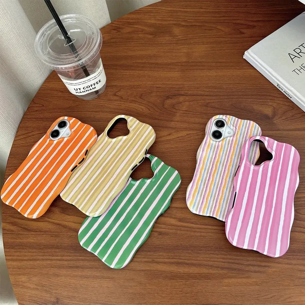 iPhone 2-in-1 striped phone case in various colors on a wooden table with a coffee cup.
