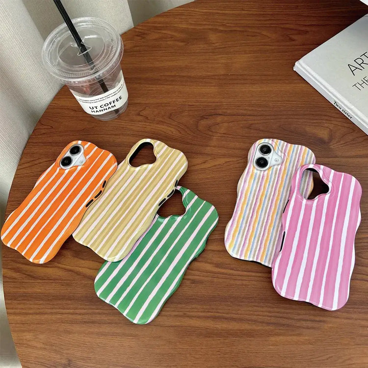iPhone 2-in-1 striped phone case in various colors on a wooden table with a coffee cup.