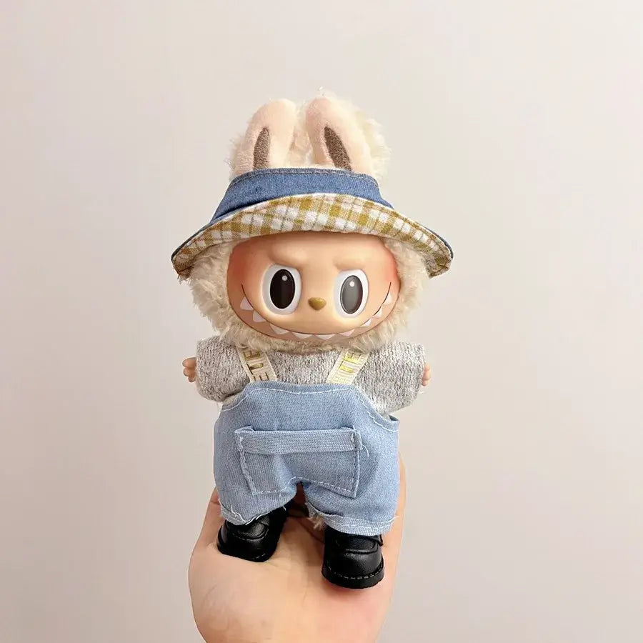 Labubu doll clothes 17cm on a cute doll wearing a floppy hat and overalls, showcasing trendy casual style.